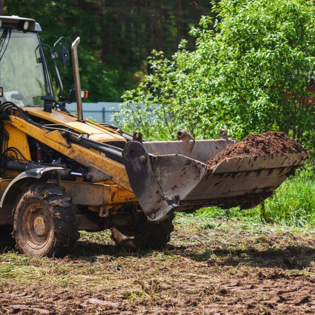 front end loader being used to pick up dirt