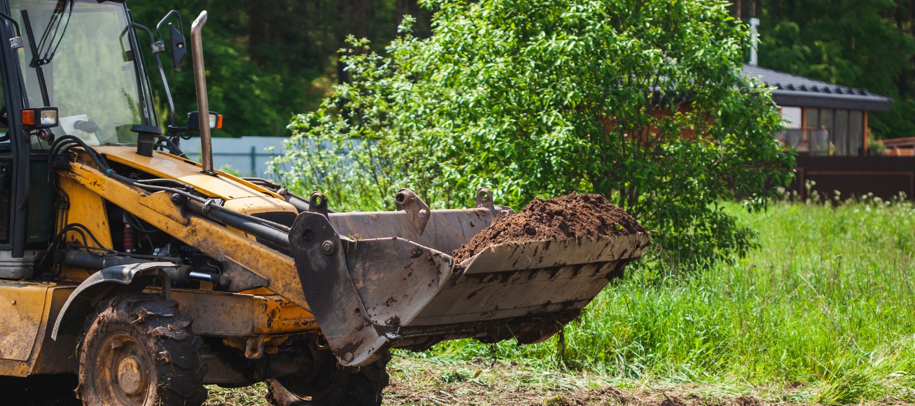 front end loader clearing land